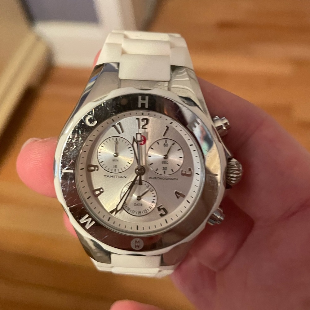 Michele watch with silver face and white rubber band.